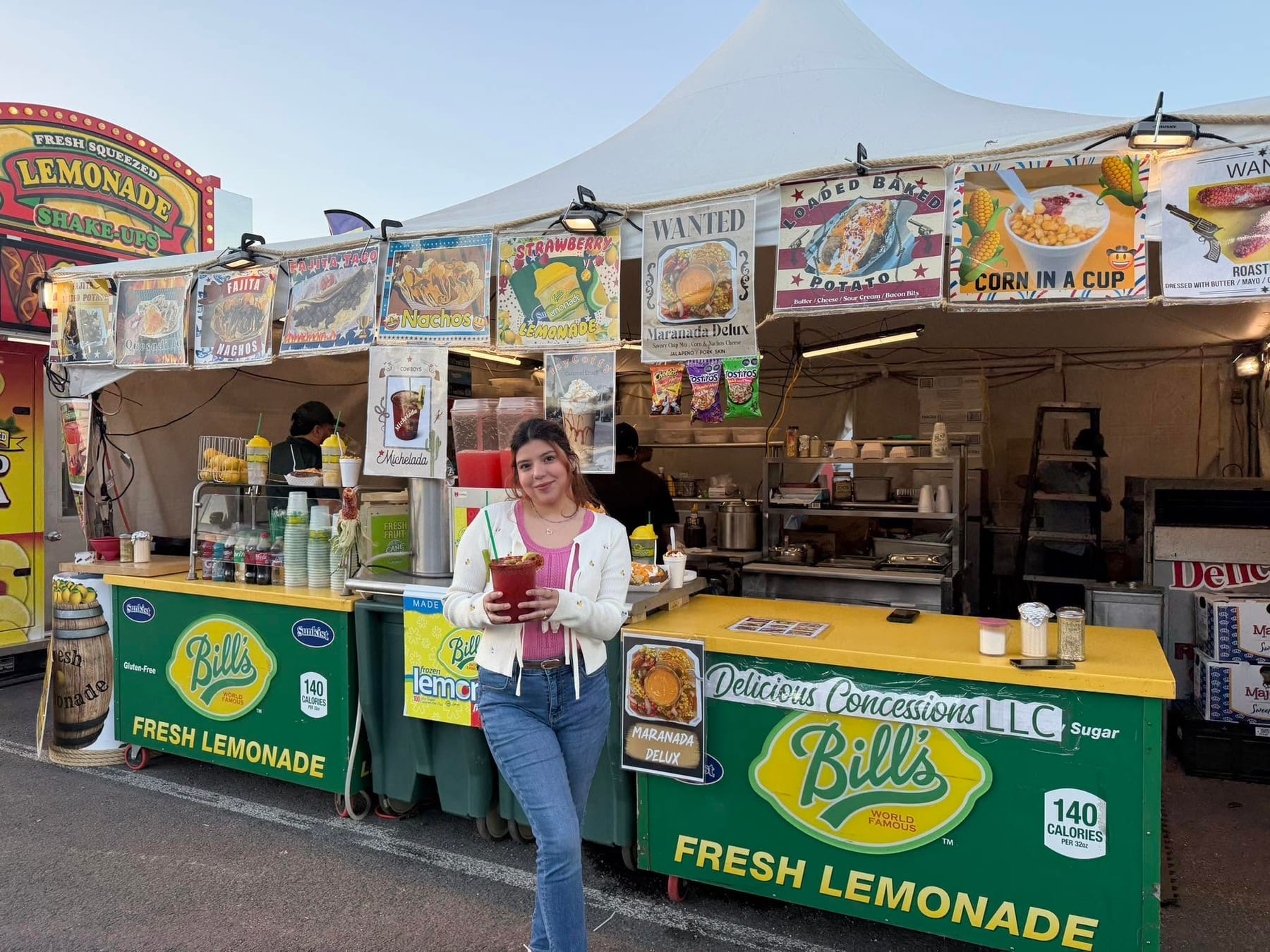 The Delicious Concessions stand with menu banners and Bill's fresh lemonade counters